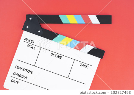 The Filmmaker profession. Clapperboard on red background. 102817498