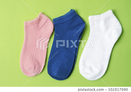 The Socks of different colors on green color background. The Socks of different colors on green color background. 102817890