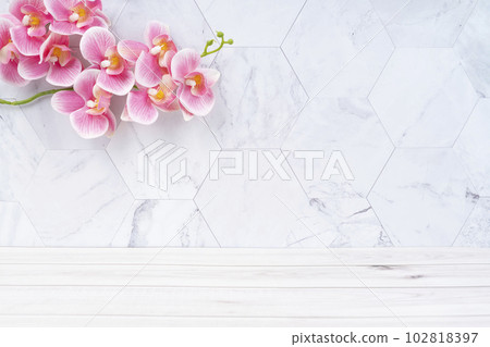 The Wooden floor and pink color orchid decorate on marble background, empty room for background. The Wooden floor and pink color orchid decorate on marble background, empty room for background. 102818397