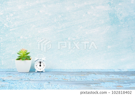 The Alarm clock and plant pot on blue wooden floor with copy space for your design. 102818402