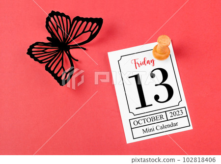 The Calendar Friday the 13th on mini calendar with black color butterfly paper on red background. 102818406