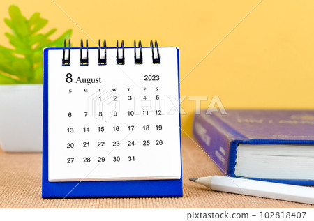 The August 2023 desk calendar with a book. 102818407