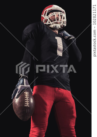 Football player on dark background Football player on dark background 102821171