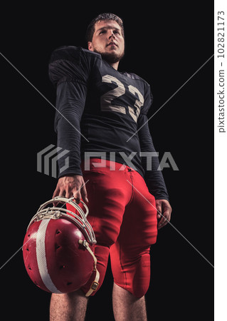 Football player on dark background Football player on dark background 102821173