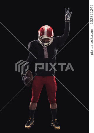Football player on dark background Football player on dark background 102821245