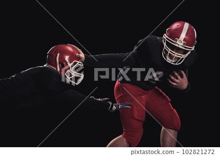 Football player on dark background Football player on dark background 102821272
