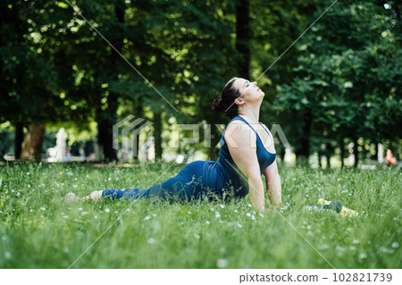 Fitness Recovery, Active Recovery: Reduce Fatigue and Enhance Performance. Overtraining and Muscle recovery, Muscle strains, risk of getting injured. Plus size fitness woman stretching after workout. 102821739