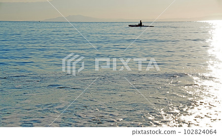 Relaxing kayaking on calm waters offshore Relaxing kayaking on calm waters offshore 102824064