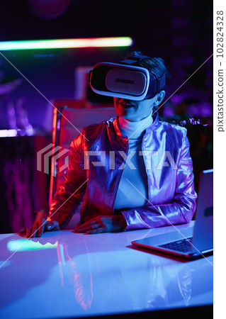 stylish business woman in virtual reality goggles in office 102824328