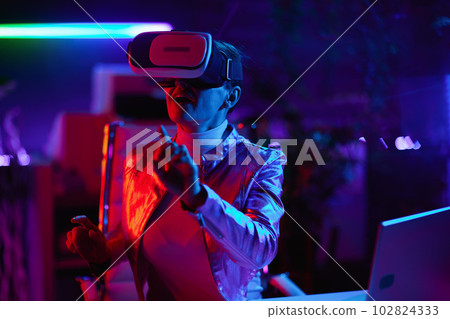 trendy female in vr headset in modern office 102824333