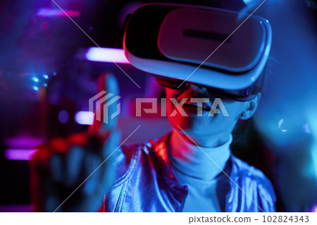 happy trendy woman in vr headset exploring metaverse 102824343
