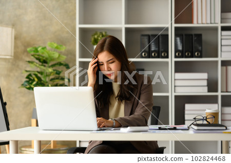 Upset asian businesswoman looking at laptop, frustrated about business failure in office Upset asian businesswoman looking at laptop, frustrated about business failure in office 102824468