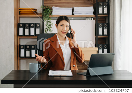 Business woman using tablet and laptop for doing math finance on an office desk, tax, report, accounting, statistics, and analytical research concept in office. 102824707