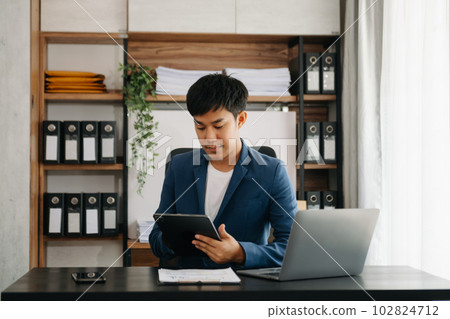 business man executive manager looking at laptop watching online webinar training or having virtual meeting video conference doing market research working in office. business man executive manager looking at laptop watching online webinar training or having virtual meeting video conference doing market research working in office. 102824712