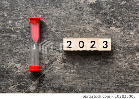 New Year 2023 sand timer. Resolution, time, plan, goal, motivation, reboot, countdown and New Year holiday concepts. Hourglass with number 2023 New Year 2023 sand timer. Resolution, time, plan, goal, motivation, reboot, countdown and New Year holiday concepts. Hourglass with number 2023 102825003