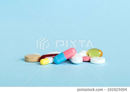 Many different colorful medication and pills perspective view. Set of many pills on colored background 102825004