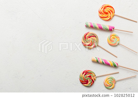 Set of colorful lollipops on colored background. Summer concept. Party Happy Birthday or Minimalist Concept Set of colorful lollipops on colored background. Summer concept. Party Happy Birthday or Minimalist Concept 102825012
