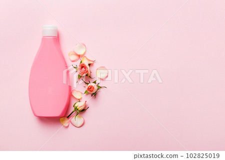 Fancy healthcare bottles for cream with rose flower. Natural oranic spa cosmetics concept. Mockup, template, Top view 102825019