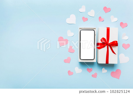 Opened gift box with ribbon and phone on color background, top view. Blank open box packaging mockup , Template for your design - branding mockup 102825124