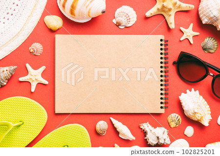 Blank writing book with summer beach accessories on background, copy space. Flat lay with copy space Blank writing book with summer beach accessories on background, copy space. Flat lay with copy space 102825201