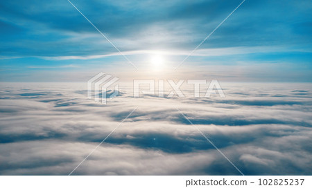 Aerial view from a drone flying above the clouds 102825237