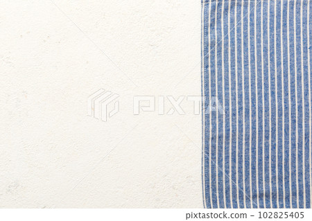 top view with blue kitchen napkin isolated on table background. Folded cloth for mockup with copy space, Flat lay. Minimal style 102825405