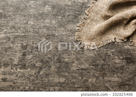 Old burlap fabric napkin, sackcloth on table background. top view with copy space 102825406