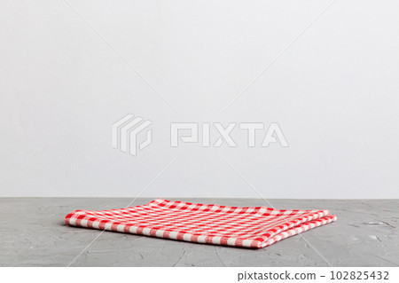 top view with red empty kitchen napkin isolated on table background. Folded cloth for mockup with copy space, Flat lay. Minimal style 102825432