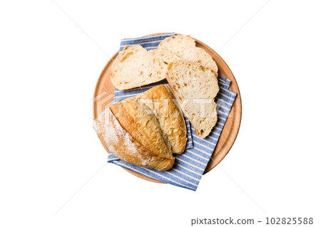 Freshly baked bread slices on cutting board isolated on white background . top view Sliced bread 102825588