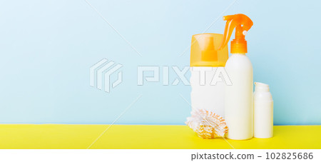 Beach accessories. Moisturiser sunscreen suntan lotion bottle for UVB skincare protection in summer with seashells on colored background. Mock up with copy space Beach accessories. Moisturiser sunscreen suntan lotion bottle for UVB skincare protection in summer with seashells on colored background. Mock up with copy space 102825686