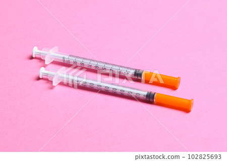 Top view of insulin syringes ready for injection on colorful background. Diabetic concept with copy space Top view of insulin syringes ready for injection on colorful background. Diabetic concept with copy space 102825693