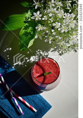 Fresh Berry Smoothie, Paper Straws and Star of Bethlehem Flowers in vase Fresh Berry Smoothie, Paper Straws and Star of Bethlehem Flowers in vase 102825848