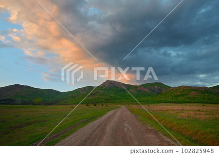 Road in Macin Mountains, Romania at Sunset Road in Macin Mountains, Romania at Sunset 102825948