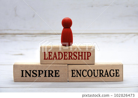 Leadership, Inspire and Encourage text on wooden blocks with red figure on top. Leadership concept. Leadership, Inspire and Encourage text on wooden blocks with red figure on top. Leadership concept. 102826473