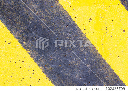 Background or texture Abstract. Top view of Yellow black caution warning lines on concrete floor grunge . Beautiful pattern used to make wallpaper website along walls of houses, building. Background or texture Abstract. Top view of Yellow black caution warning lines on concrete floor grunge . Beautiful pattern used to make wallpaper website along walls of houses, building. 102827709