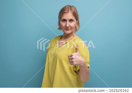 calm middle aged woman with pointing finger at camera calm middle aged woman with pointing finger at camera 102828162