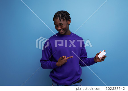 handsome african young man with money card in his hand handsome african young man with money card in his hand 102828342