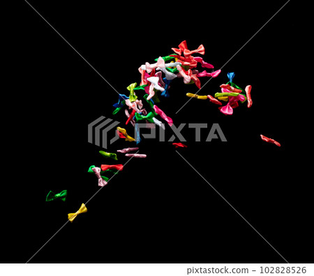 Bows flying in air. Many small ribbon in red, blue, pink, yellow throw explosion. Small Bow floating abstract black background isolated, high speed shutter freeze action 102828526