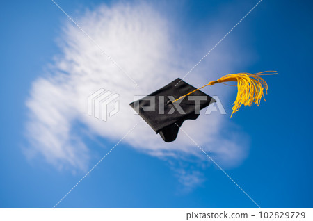 Graduation cap flies against the blue sky. Graduation cap flies against the blue sky. 102829729