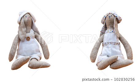Tilda bunnies handmade in white clothes to decorate the house on a transparent background to decorate the apartment. Photo in high quality. PNG. Horizontal. 102830256