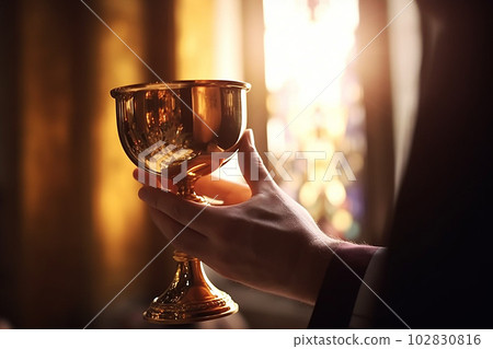 Priest hand holding golden chalice of wine, sun rays throuth curch window. Generative AI Priest hand holding golden chalice of wine, sun rays throuth curch window. Generative AI 102830816
