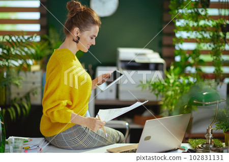 business owner woman using tablet PC and working with documents business owner woman using tablet PC and working with documents 102831131