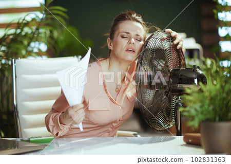 modern business woman at work suffering from summer heat modern business woman at work suffering from summer heat 102831363