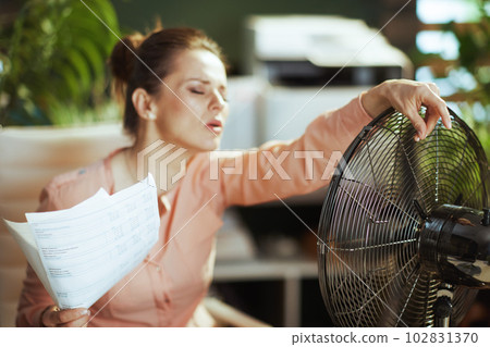 female employee in green office suffer from heat 102831370
