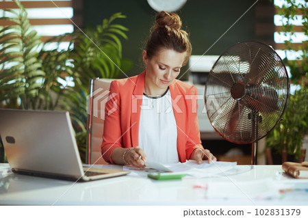 modern 40 years old bookkeeper woman in modern green office modern 40 years old bookkeeper woman in modern green office 102831379