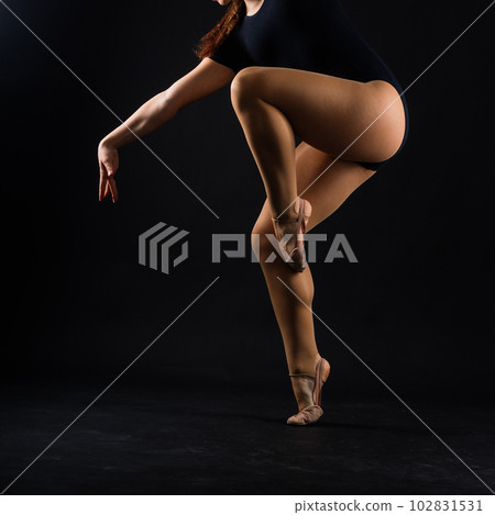 Flexible girl, rhythmic gymnastics artist jumping on white dark background. Grace in motion, action. 102831531
