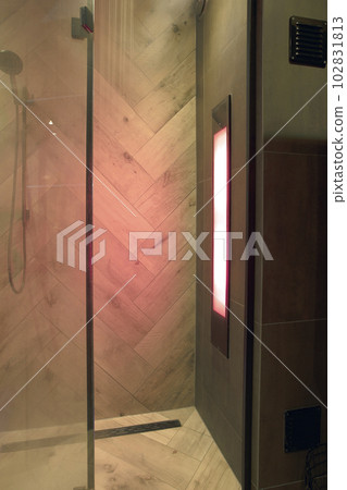 Sunshower in a bathroom,with uv lights, lights glowing while water is flowing. worked Solarium with ultraviolet light. Infra red lights body relexation 102831813