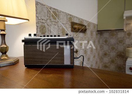 Vintage radio on a wooden table in the interior of the room