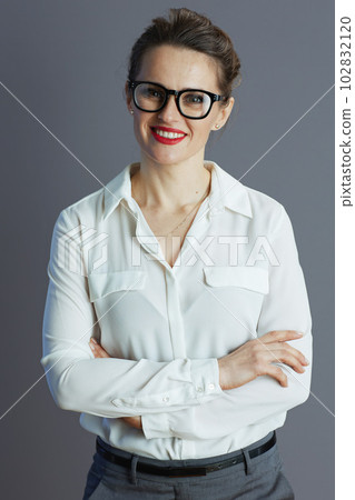 happy young small business owner woman against gray background happy young small business owner woman against gray background 102832120