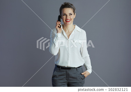 woman worker talking on old radio phone isolated on gray woman worker talking on old radio phone isolated on gray 102832121